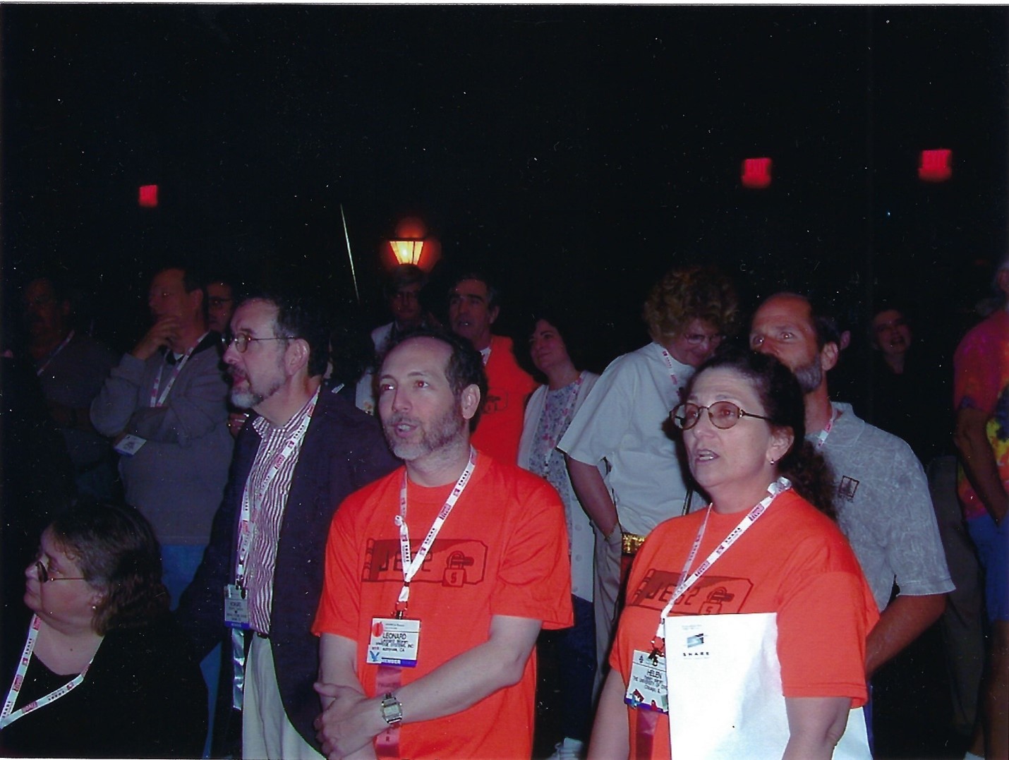 woman with long dark hair in a red SCIDS shirt at the SHARE singalong wearing glasses